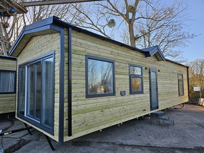 Lot 717 - Unused The Steel Holiday Homes Ltd 36' x 12' (Steel Structure) 2 Bedroom Timber Clad Lodge, Shower Room, Central Heating (Fully Furnished - Sofas, Beds, Fire, Dining Table, Microwave)